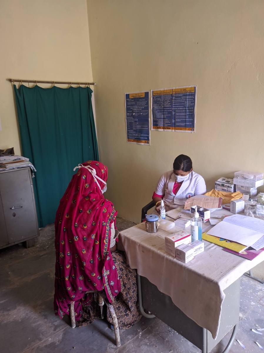 A health worker attending to a woman at a health centre