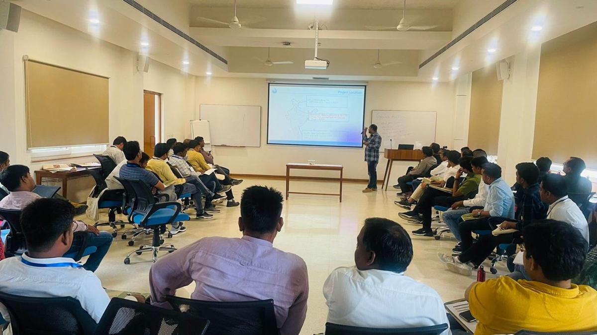 A facilitator presenting to participants at a training workshop
